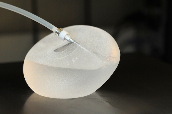 A picture taken on January 12, 2012 in Boissy-l'Aillerie, northern Paris, shows a  breast implant produced by French implant manufacturer, Sebbin laboratories, being filled up with silicone.  Around 300,000 women in 65 countries have received implants made by Poly Implant Prothese (PIP), a now-defunct manufacturer in southern France that is at the centre of the storm, although some figures are much higher.  AFP PHOTO MIGUEL MEDINA (Photo credit should read MIGUEL MEDINA/AFP/Getty Images)